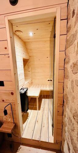 a small wooden sauna with a bench in it at Maison cosy avec sauna en montagne in Saint-Jacques-des-Blats