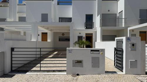 a building with two refrigerators in front of it at BS House Praia da Lota - Casa à Beira-Mar in Vila Nova De Cacela