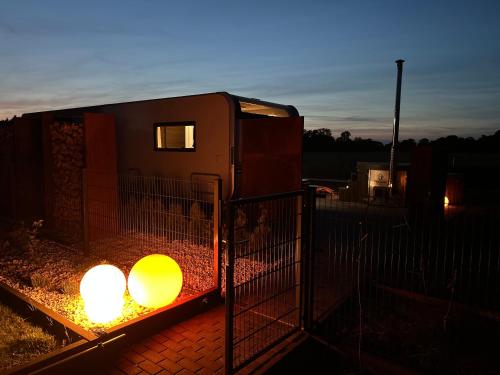 a trailer with two lights in a fence at Romantische Wellness-Oase in Haasow