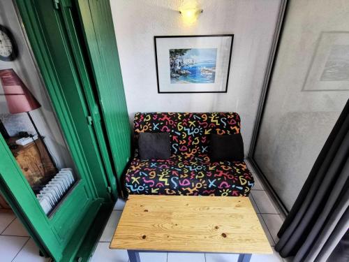 Cette petite chambre comprend un canapé et une table. dans l'établissement Résidence Les Portes De Catalogne - Studio pour 4 personnes avec loggia, Le Barcarès. Réf: 8PC_J4 MAE-8453, au Barcarès