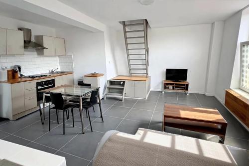 a kitchen and living room with a table and chairs at Saint Georges 31 - pairi daiza - Shape Mons in Braine-le-Comte