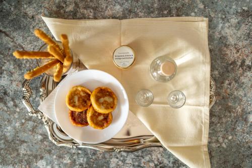 a plate of food with pretzels and french fries on a table at Serenity Guesthouse in Sitia