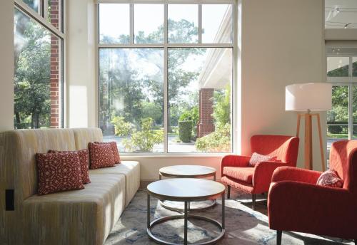 a living room with a couch and two chairs and a table at Hilton Garden Inn Tampa East Brandon in Tampa