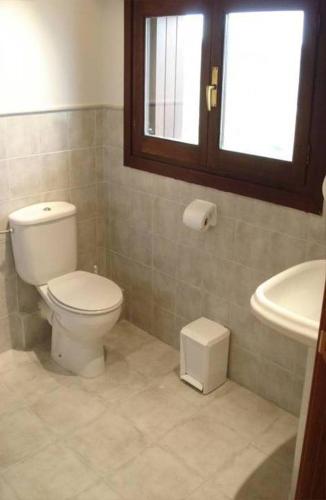 a bathroom with a toilet and a sink at Casa Rural Olazi in Oiartzun