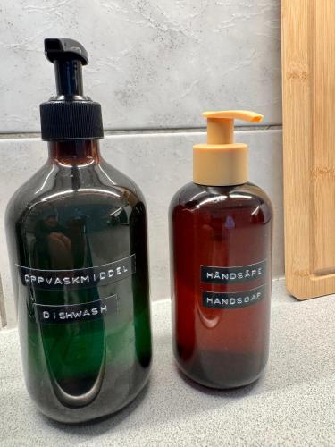 two bottles of soap sitting next to each other at Stor attraktiv studioleilighet i sentrum in Trondheim