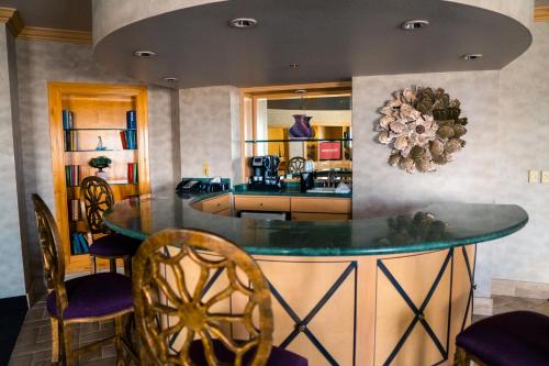 a kitchen with a table and chairs in a room at Arizona Charlie's Decatur in Las Vegas