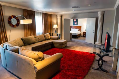 a living room with a couch and a red rug at Arizona Charlie's Decatur in Las Vegas