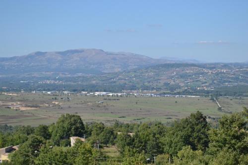 a view of a field with trees and mountains at Le Coccole in Guardiaregia
