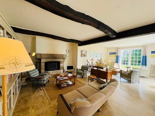 un salon avec un canapé et une cheminée dans l'établissement Maison familiale, 8 chambres, jardin clos 3000m, wifi, parking, à La Trinité-sur-Mer