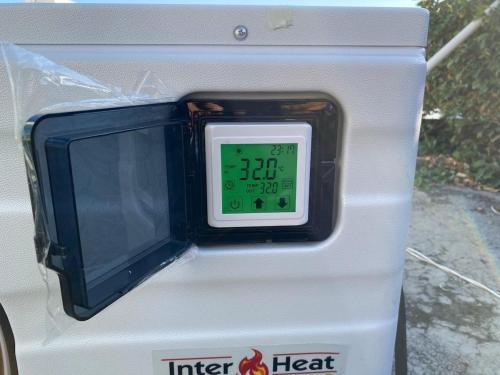 a clock on the side of a heat machine at Beautiful House with Climate Pool and Jacuzzi in Colima