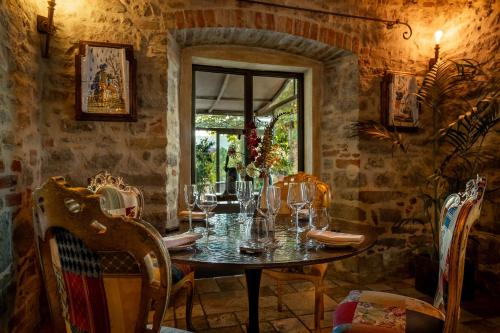 a dining room with a table and chairs and a window at I Capricci Di Merion - Resort & Spa in Tuoro sul Trasimeno