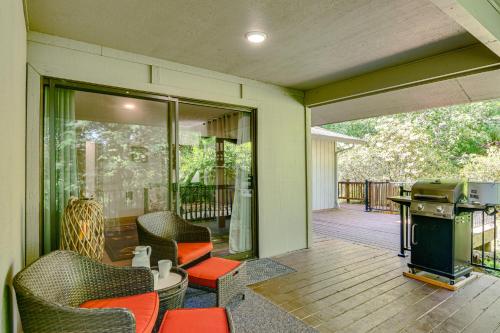 a screened porch with chairs and a grill on a patio at Riverfront Woodland Cabin Wooded and Forested Views in Woodland