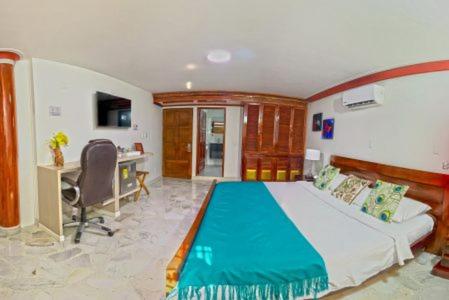 a bedroom with a large bed with a desk and a desk at HOTEL BOUTIQUE LUXURY in Cali