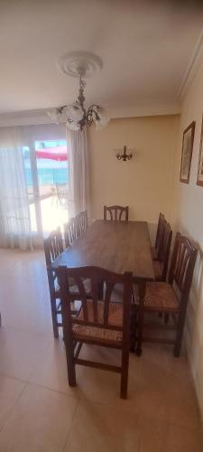 a dining room with a wooden table and chairs at Jordi's Flat close to the Beach in L'Estartit
