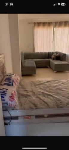 a living room with a couch and a dog laying on the floor at Villaggio lavie in Ras Sedr