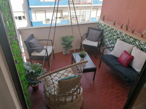 a balcony with chairs and a couch at StayinSetubal in Setúbal