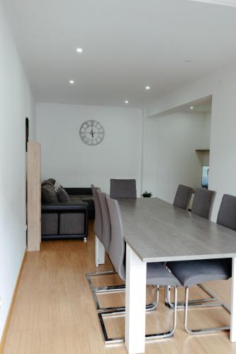 a dining room and living room with a table and chairs at StayinSetubal in Setúbal