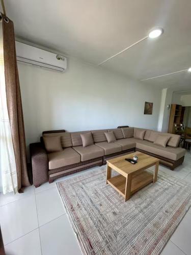 a living room with a couch and a coffee table at Kensington Seaviews in Flic-en-Flac