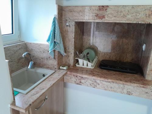 a kitchen with a sink and a counter top at Charming Town House, Limani 9 in Mirina