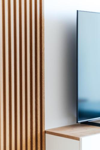 a television sitting on a shelf next to a wall at Vuelo Sobre by In Property in Becici