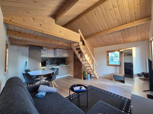 a living room with a couch and a table at Domki Schega in Podamirowo