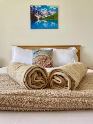 a blanket laying on top of a bed at Kensington Seaviews in Flic-en-Flac