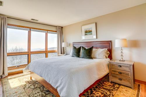 a bedroom with a bed and a large window at Pool Access: Scenic Condo in Wintergreen Resort! in Mount Torry Furnace