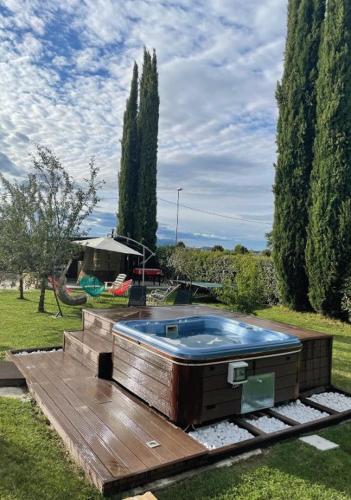 a hot tub on a wooden deck in a yard at B&B DA NONNA ANACLE in Bastia Umbra