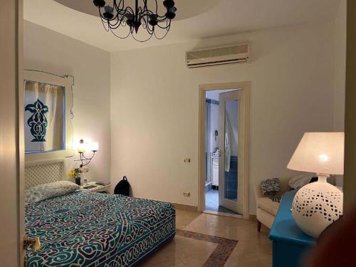 a bedroom with a bed and a couch and a lamp at Domina Coral Bay Resort in Sharm El Sheikh