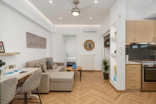 a living room with a couch and a table at Aura Apartment - next to the beach of Ayia Anna in Kría Vrísi