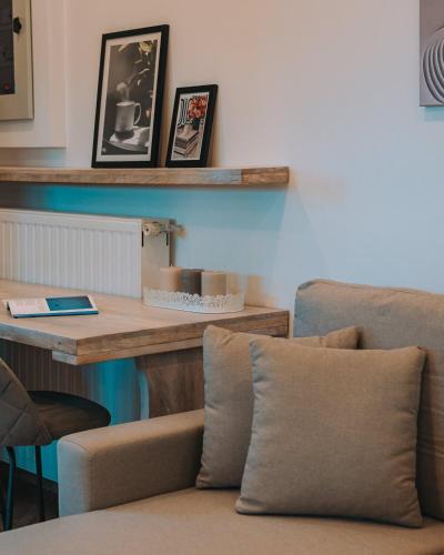 a living room with a table and a couch at Aura Apartment - next to the beach of Ayia Anna in Kría Vrísi