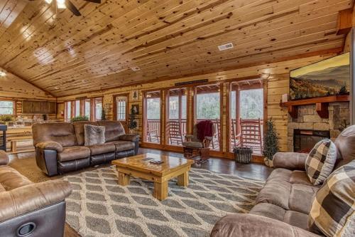 a living room with leather furniture and a fireplace at Eat, Drink and Be Beary by Avada Properties in Sevierville