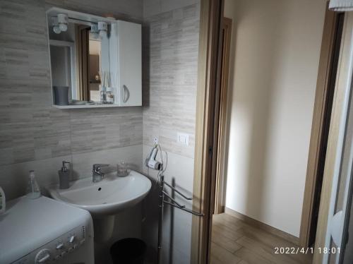 a bathroom with a sink and a mirror at Gravina House in Castellaneta