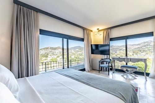 a bedroom with a bed and a desk with a view at Bombien Luxury in Bodrum City