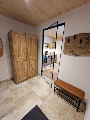 a room with a mirror and a wooden door at Das Stangenäcker in Unterammergau