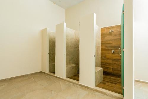 a bathroom with a shower and a glass door at Casa Jaguar in Xpu Ha