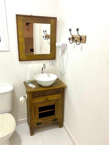 a bathroom with a sink and a mirror at BOSQUE TOQUE TOQUE Pousada in São Sebastião