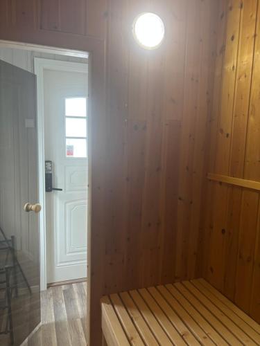 a room with a bed with a light on the wall at Maria apartment with Sauna Otta in Otta