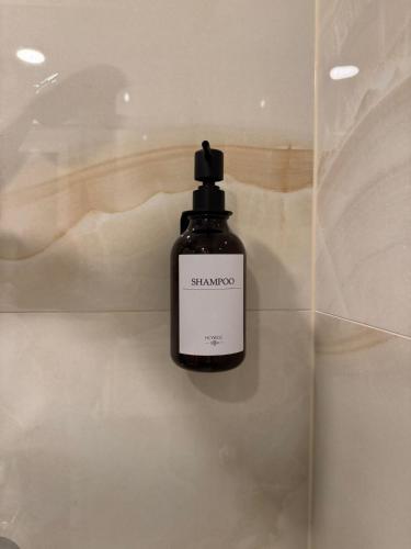 a bottle of shampoo sitting on top of a counter at Boutique Apartment - Široki Brijeg in Široki Brijeg