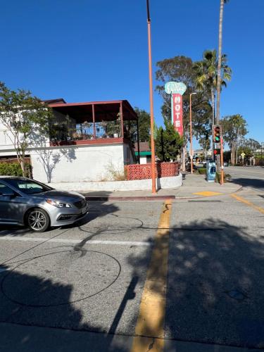 a car driving down a street with a traffic light at El Rio Motel in Glendale