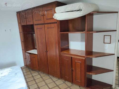 a room with a wooden book shelf and a bed at Condomínio CTC Araras, Caldas Novas - VPC in Caldas Novas