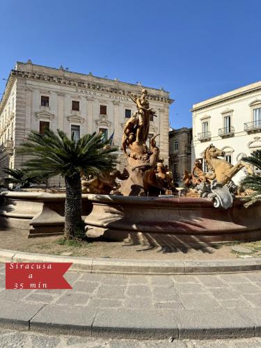 a large fountain in front of a building at La Terrazza di Cirico' in Carlentini