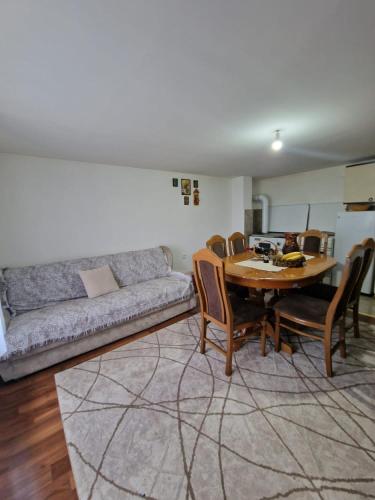 a living room with a table and a couch at Domaćinstvo Ristović in Banovo Polje