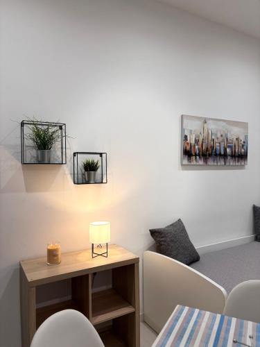 a living room with a table and some chairs at Casa di Mimì in Gela