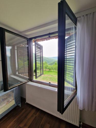 a room with a large window with a view at Domaćinstvo Ristović in Banovo Polje