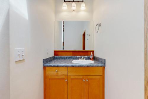 a bathroom with a sink and a mirror at Loon's Landing in Sea Ranch