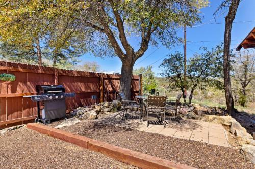 a patio with a grill and chairs next to a fence at Thumbe Butte 2-br Chalet Mtn Views5min Wsky Row in Prescott
