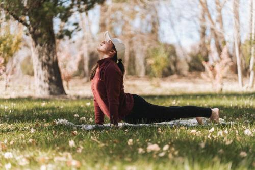 a woman sitting on the grass in a field at Valle Andino in Uspallata