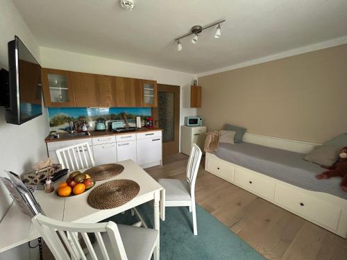 a bedroom with a bed and a table and chairs at Ferienwohnung im Fichtelgebirge - nahe der Skipiste mit Balkon & Free Parking in Mehlmeisel