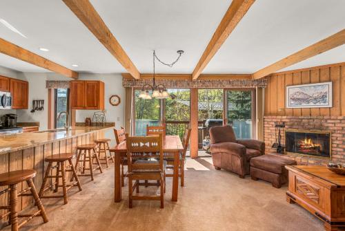 a kitchen and living room with a fireplace at Woodbridge Condo by Snowmass Vacations in Snowmass Village
